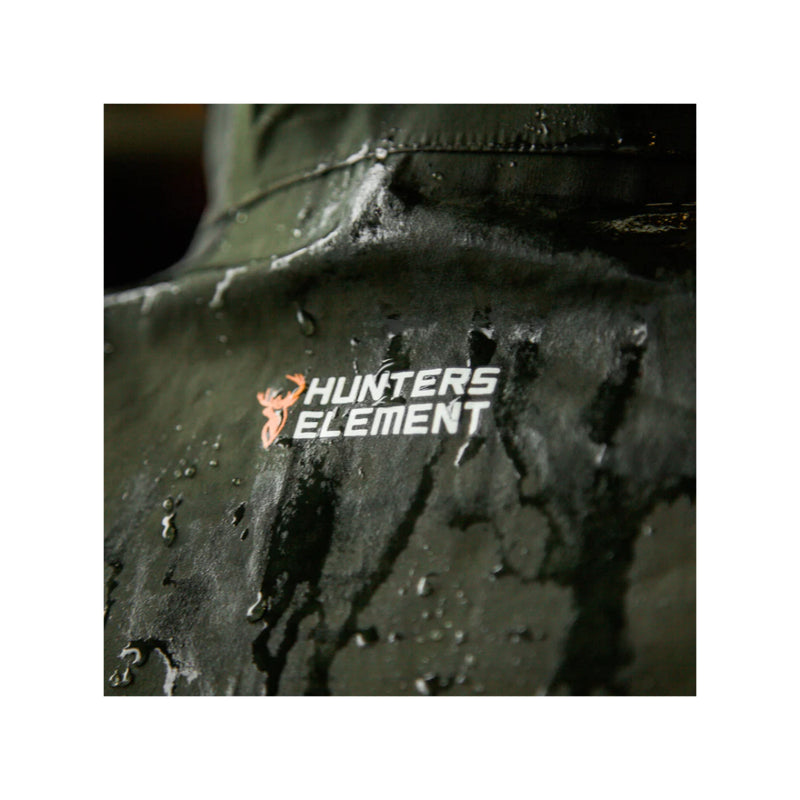 Forest Green | Hunters Element Halo Jacket Image Displaying Close Up View Of Logo On The Back, With Rain Falling On Jacket.