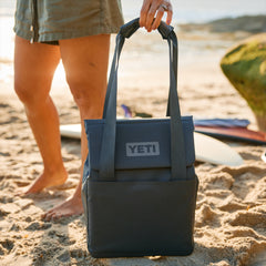 Charcoal / 14L | YETI Daytrip Insulated Tote Bag Image Showing Tote Bag Being Put Down On The Sand.