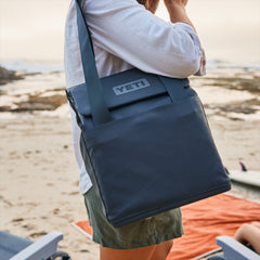 Navy / 14L | YETI Daytrip Insulated Tote Bag Image Showing Tote Bag On A Model's Shoulder For A  Day At The Beach.
