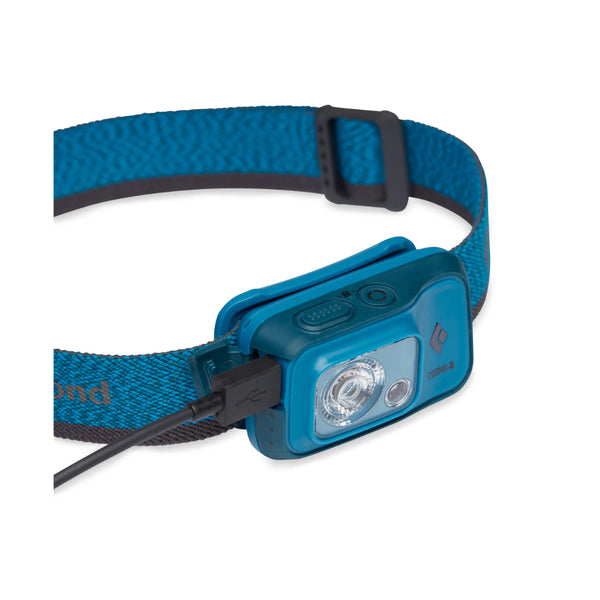 Azul | Black Diamond Cosmo R Headlamp 350 Lumens - Rechargeable Image Showing Angled Front View With Charger Cord Plugged Into The Charger Port.