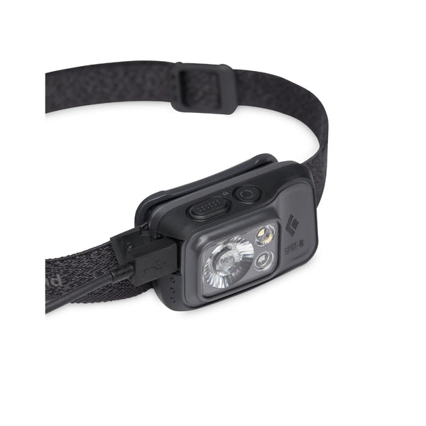 Graphite | Black Diamond Spot Headlamp 400 Lumens - Rechargeable Image Showing Close Up View Of The Charger Cord, Inserted In The Charging Port On The Headlamp.