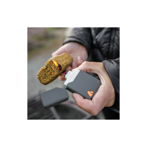 Coghlan's Plasma Lighter | Image Showing The Plasma Lighter Being Used To Light A Fire Brick.