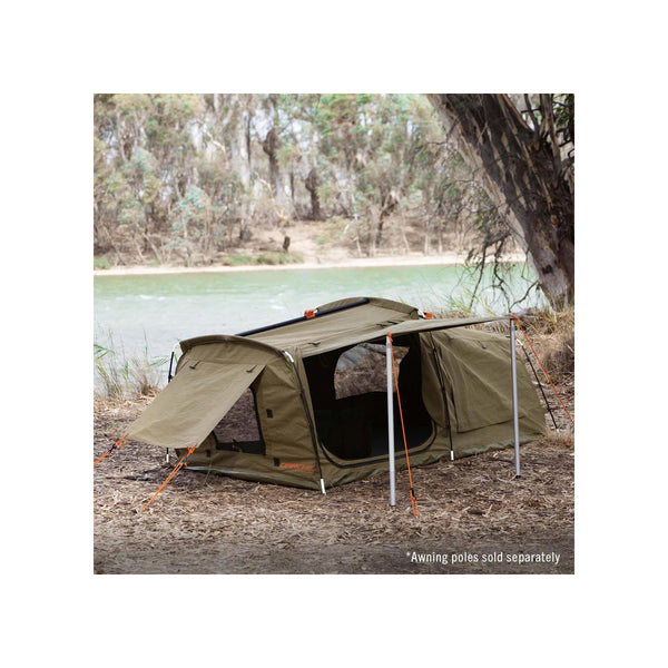 1400 / Khaki | Darche Dirty Dee Swag With 70mm Mattress Image Showing The Swag Set Up Under A Tree, Next To A River.