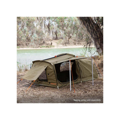 1400 / Khaki | Darche Dirty Dee Swag With 70mm Mattress Image Showing The Swag Set Up Under A Tree, Next To A River.