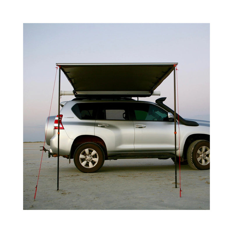 2.5m x 2.5m | Darche Eclipse Slimline Awning Image Showing Front View Of Awning Set Up On A Beach.