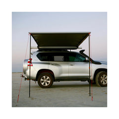 2.5m x 2.5m | Darche Eclipse Slimline Awning Image Showing Front View Of Awning Set Up On A Beach.