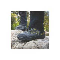 Slate | Desolve Rise Boots Image Showing Close Up Of Model With Boots On Standing On A Rock.