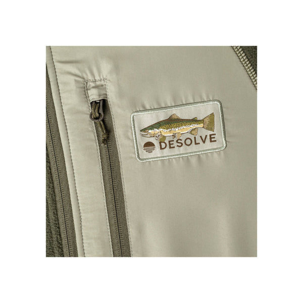 Dark Sage | Desolve Zephyr Top Trutta Image Showing Close Up Of Chest Logo And Zippered Pocket.
