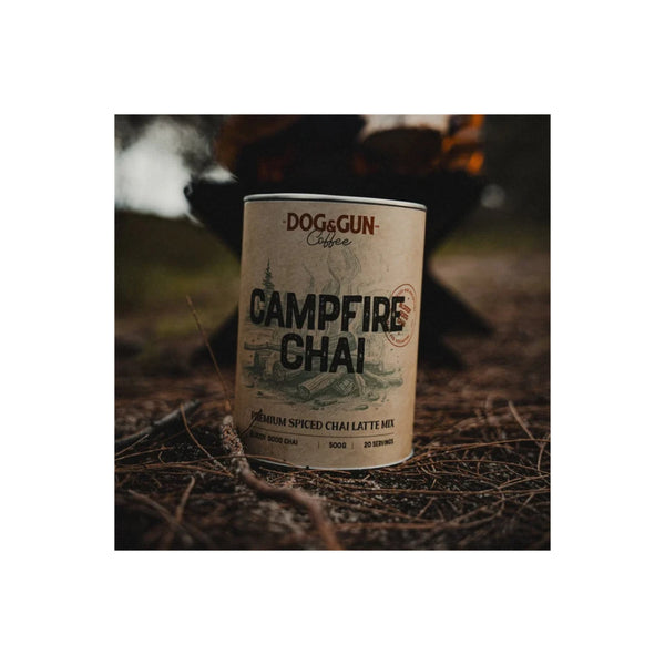 500g | Dog & Gun Campfire Chai Image Showing The Tin Of Campfire Chai Infront Of A Campfire.