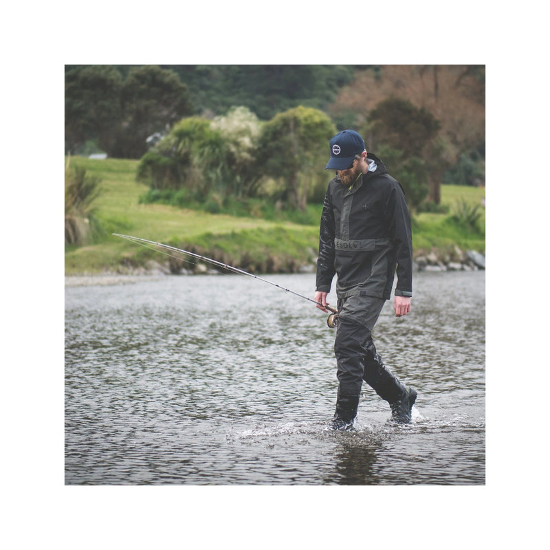 Slate | Desolve Rise Wader Image Showing Model Walking Through Water With Fishing Pole In Hand.