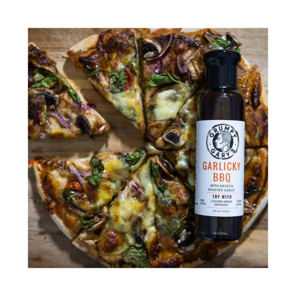 245ml | Grumpy Gary's Garlicky BBQ Sauce With Dates And Roasted Garlic Image Showing The Sauce Being Used On A Pizza.