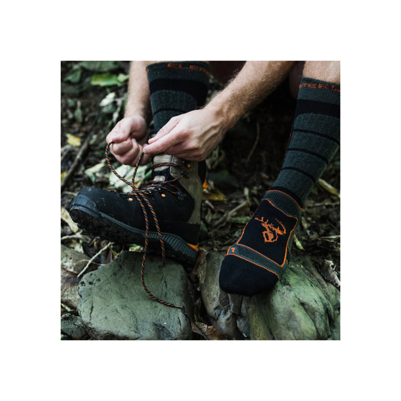 Forest Green | Hunters Element Apex Sock Image Showing Socks Being Worn On A Hunt, One Foot In A Boot, Other Foot Just In A Sock.