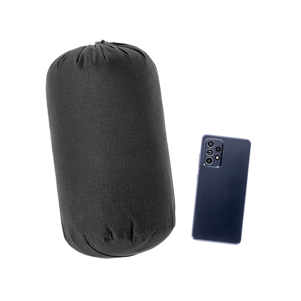 Black | Hunters Element Forge Jacket Image Showing Jacket Packed Down Next To A Mobile For For Size Comparison.