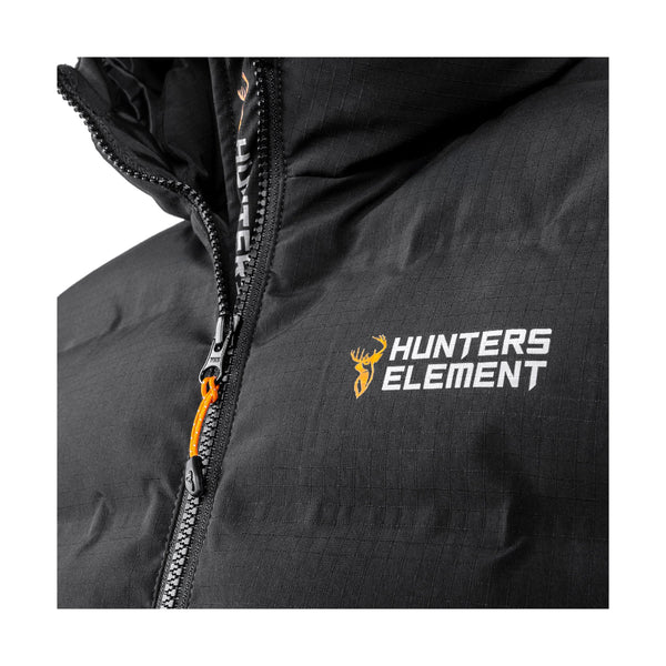 Black | Hunters Element Forge Vest Image Showing Close Up View Of The Hunters Element Logo With The Zipper In The Background.