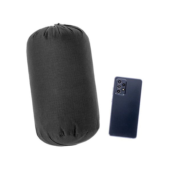 Black | Hunters Element Forge Vest Image Showing The Vest Packed Down Into Supplied Stuff Sack, Next To A Mobile Phone For Size Compression.