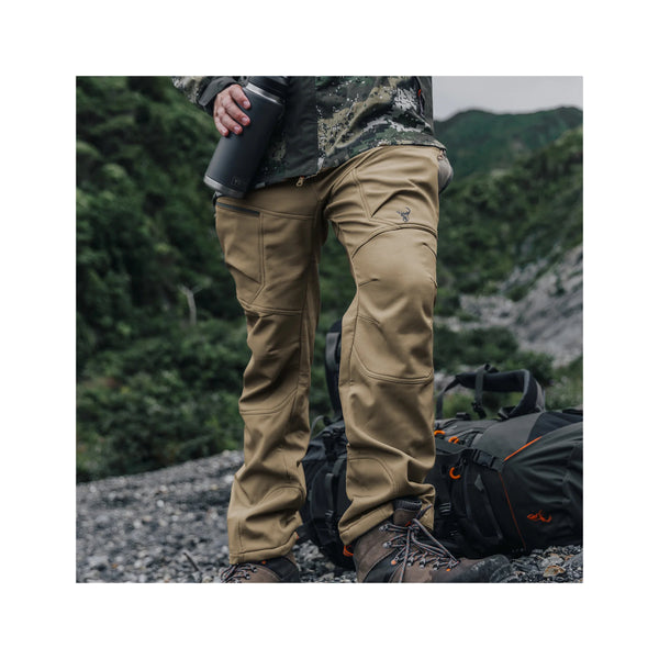 Tussock | Hunters Element Men's Legacy Pants Image Showing Front View Of The Pants Being Worn Out On A Hike.