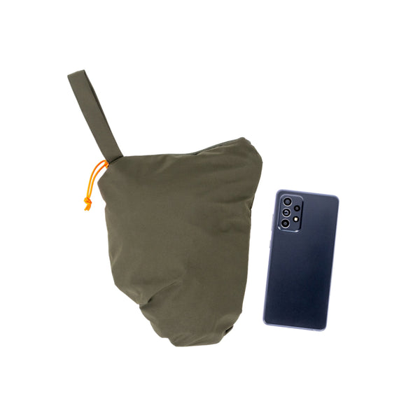 Forest Green | Hunters Element Storm Pants Image Showing The Pants Packed Down Into Its Self Next To A Mobile Phone For Size Comparison.