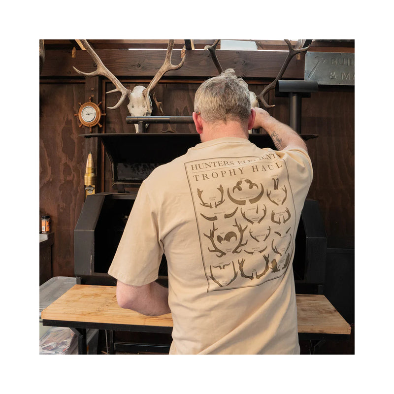 Sand | Hunters Element Trophy Haul Tee Image Showing Shirt Being Worn While Cooking Up A BBQ, Back View.