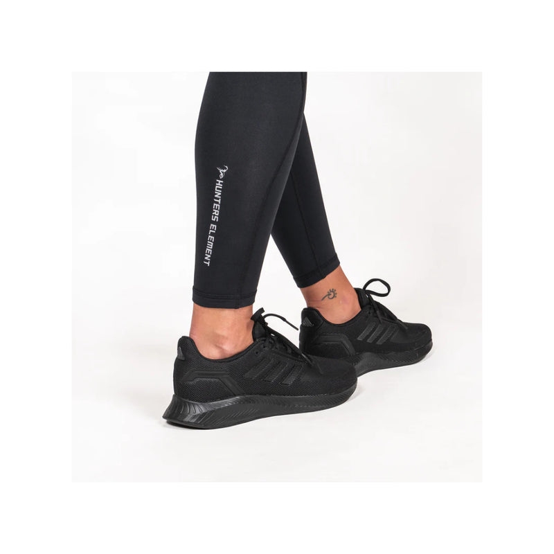 Black | Hunters Element Women's Ice Leggings Image Displaying Close Up View Of Ankle Cuffs And Logo.