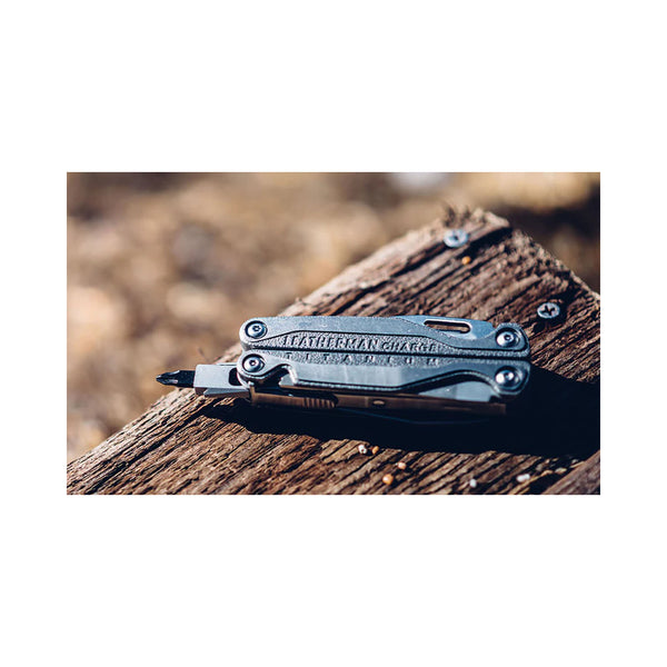 Leatherman Charge TTI Plus | Image Showing Leatherman On A Block Of Wood, With The Phillips Head Screw Diver Folded Out.