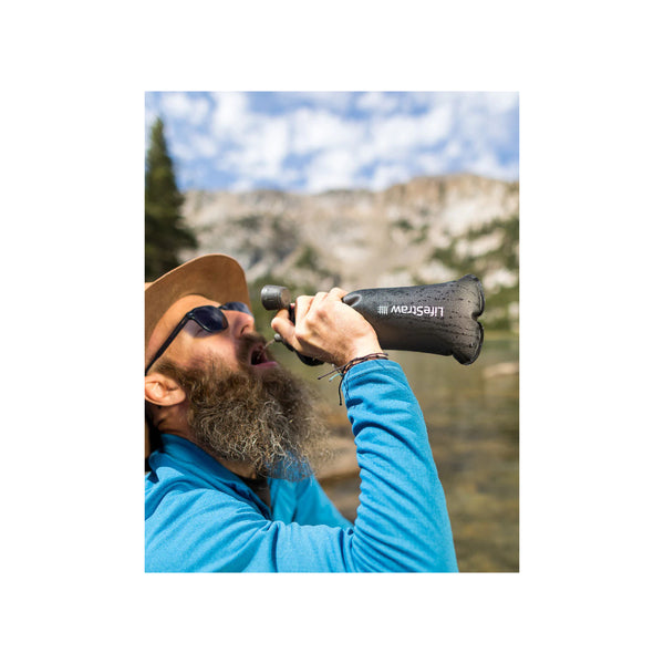 LifeStraw Peak Collapsible Squeeze Bottle Image Showing Water Being rank Out Of The Bottle.
