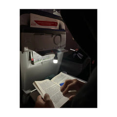 Luci Solar Anywhere Site Lights | Image Showing Bulb Being Used As a Book Light, At Night.