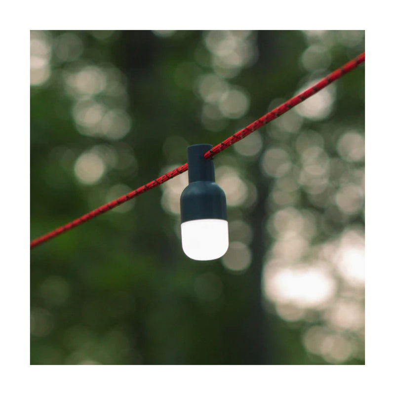 Luci Solar Anywhere Site Lights | Image Showing Bulb Hanging On A Over Head String, Light On.