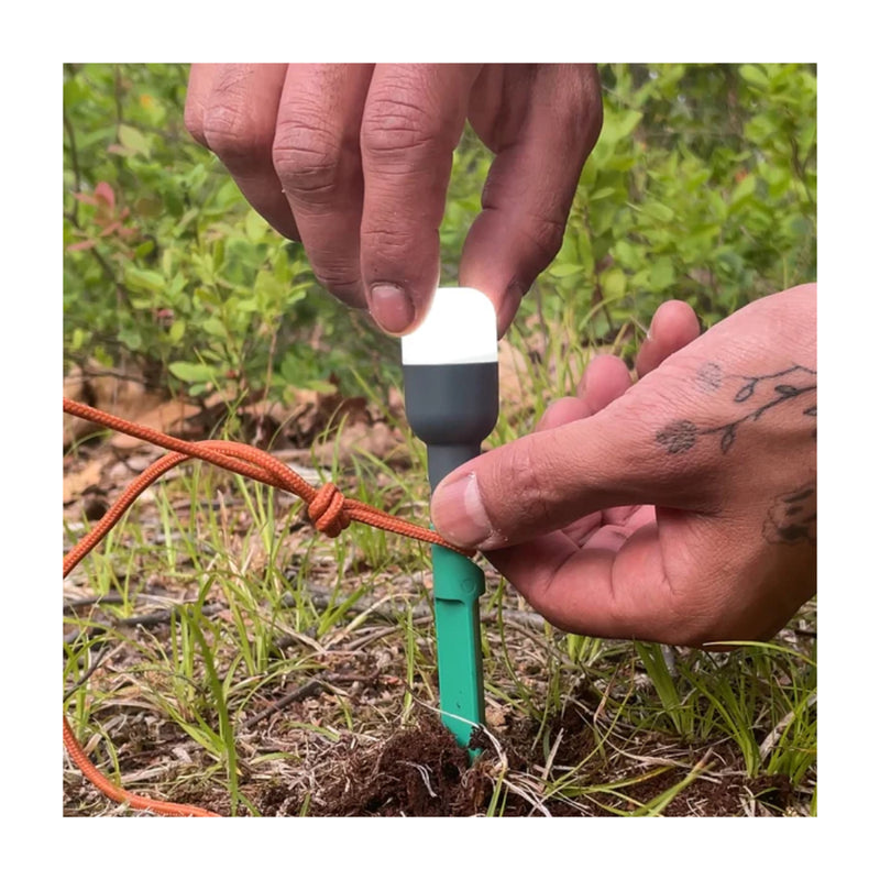 Luci Solar Anywhere Site Lights | Image Showing Stake In Ground Guy Rope On, Putting Bulb On.