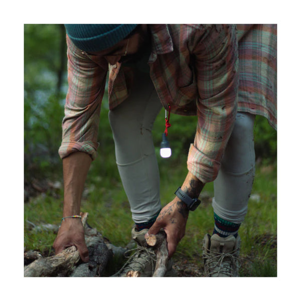 Luci Solar Anywhere Site Lights | Image Showing Bulb Attached To A T-Shirt, Light on.