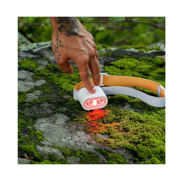 Luci-Solar HeadLamp And FlashLight | Image Showing HeadLamp Being Turned On, In Red Mode, On A Rock.