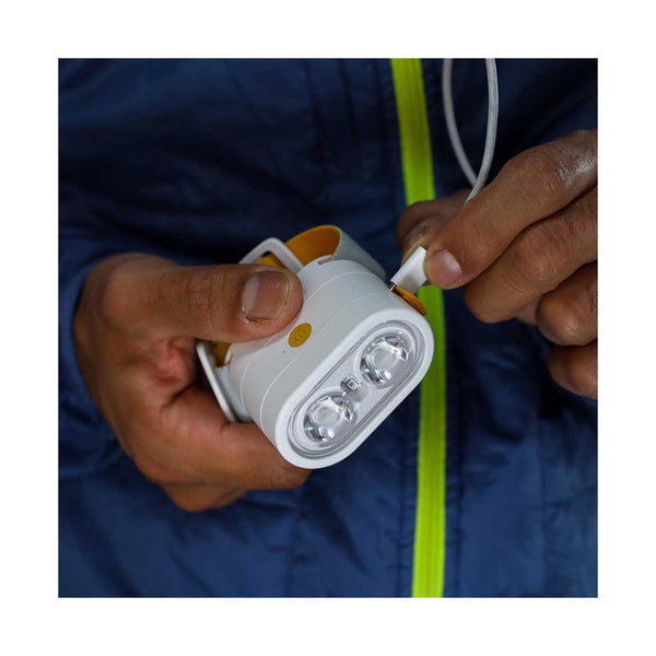 Luci-Solar HeadLamp And FlashLight | Image Showing USB-C Charger Cord Being Plugged Into The HeadLamp Body.