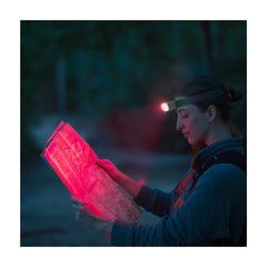 Luci-Solar HeadLamp And FlashLight | Image Showing The HeadLamp On Adjustable Strap, Being Used In Red LIght Mode.