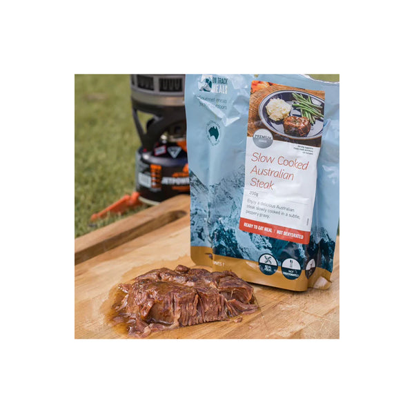 200g | On Track Slow Cooked Australian Steak Image Showing The Steak Out Of The Packet On A Chopping Board.