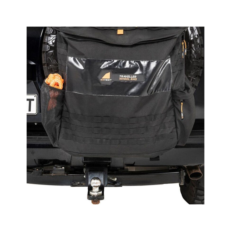 Oztent Traveller Pro Wheel Bag | Black Image Showing Front Of Bag, Side Pockets Full, Also Displaying The MOLLE System On The Front.