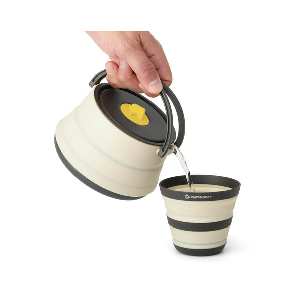White | Sea To Summit Frontier Ultralight Cook Set Image Sowing Kettle Being Used To Pour Water Into A Collapsible Cup.