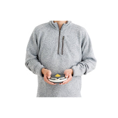 1.1 L / White | Sea To Summit Frontier Ultralight Collapsible Kettle Image Showing Kettle Collapsed In The Hands Of A Model, Showing Size Comparison.