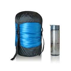 Teal | Sherpa Pemba 0 Sleeping Bag Image Showing Sleeping Bag In Compression Sack Standing Next To A Water Bottle.