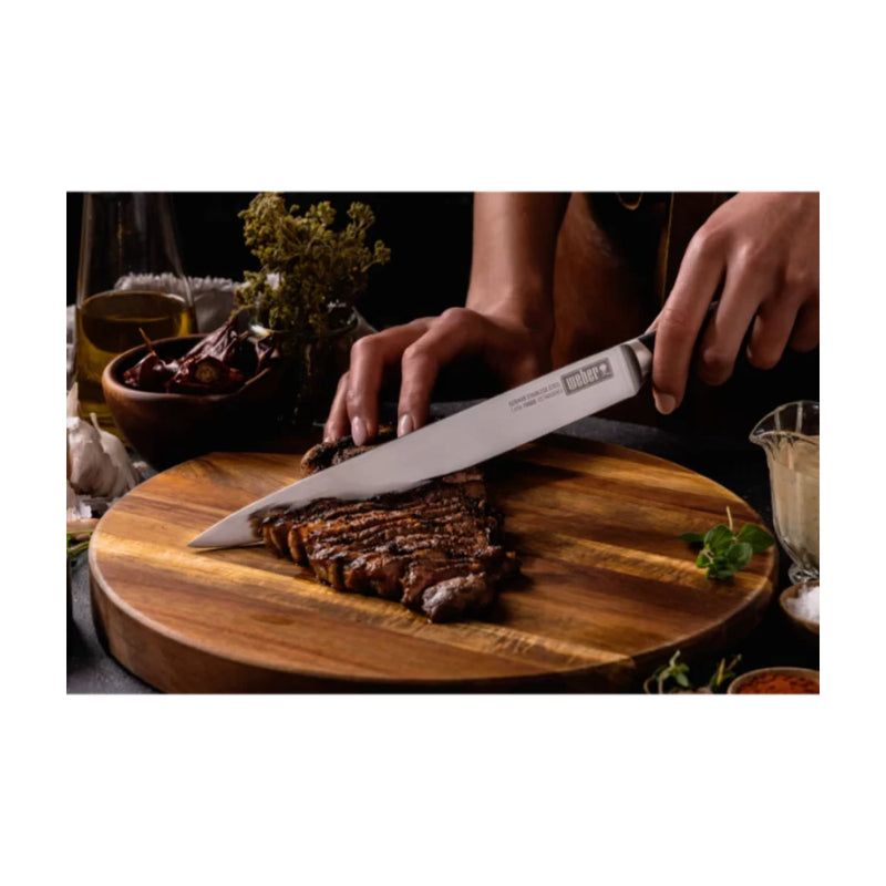Stainless Steel | Weber 25 cm Carving Knife. Shown Carving A Steak.