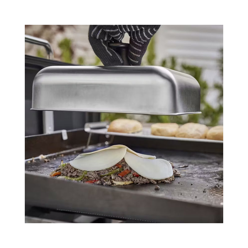 Stainless Steel | Weber Basting Dome Image Showing Dome Being Placed Over Food On A Weber BBQ Hot Plate.