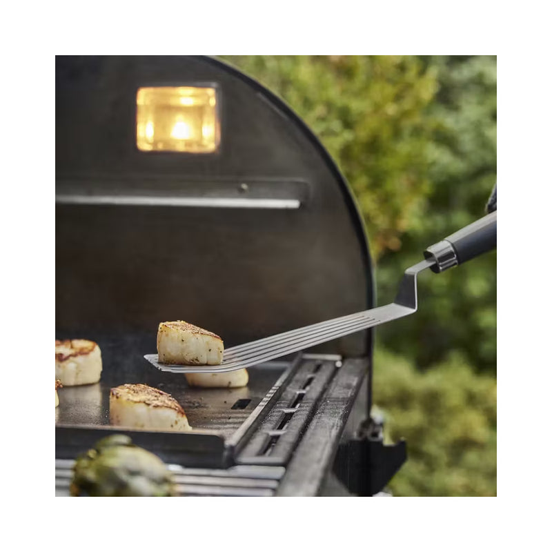 Stainless Steel | Weber Griddle Spatula Image Showing Spatula Flipping Pieces Of Fish On A BBQ.