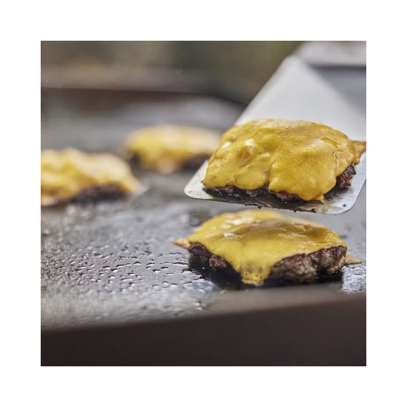 Stainless Steel | Weber Griddle Spatula Image Showing Burger Patties Being Flipped With The Griddle Spatula.