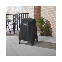 Black | Weber Lumin BBQ And Stand Cover Image Showing Cover On The BBQ, Outside On A Patio.