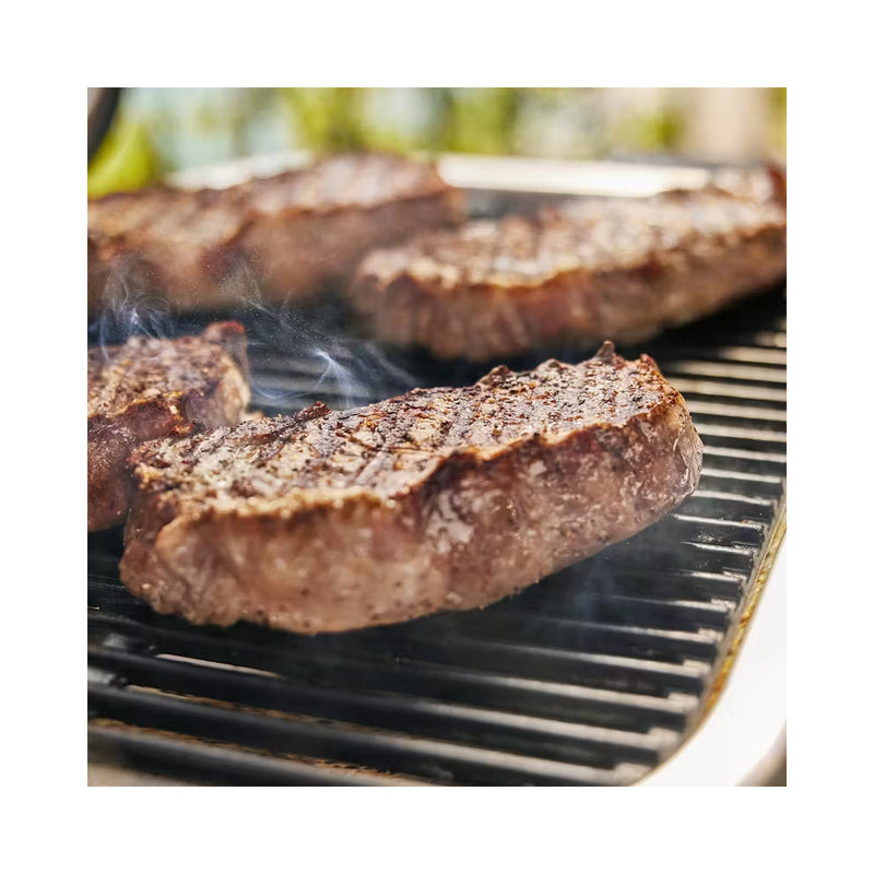 Black | Weber Lumin Electric BBQ Image Showing Close Up View Of Grill Plate, With meat Cooking.