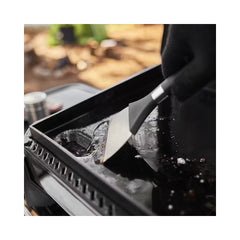 Black | Weber Slate Tabletop Griddle 17'' Image Showing Close Up Of Hot Plate Being Cleaned.