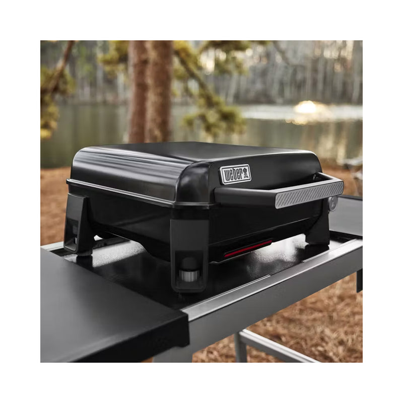 Black | Weber Slate Tabletop Griddle 17'' Image Showing Angled View Of BBQ, Lid Down , On A Stand.