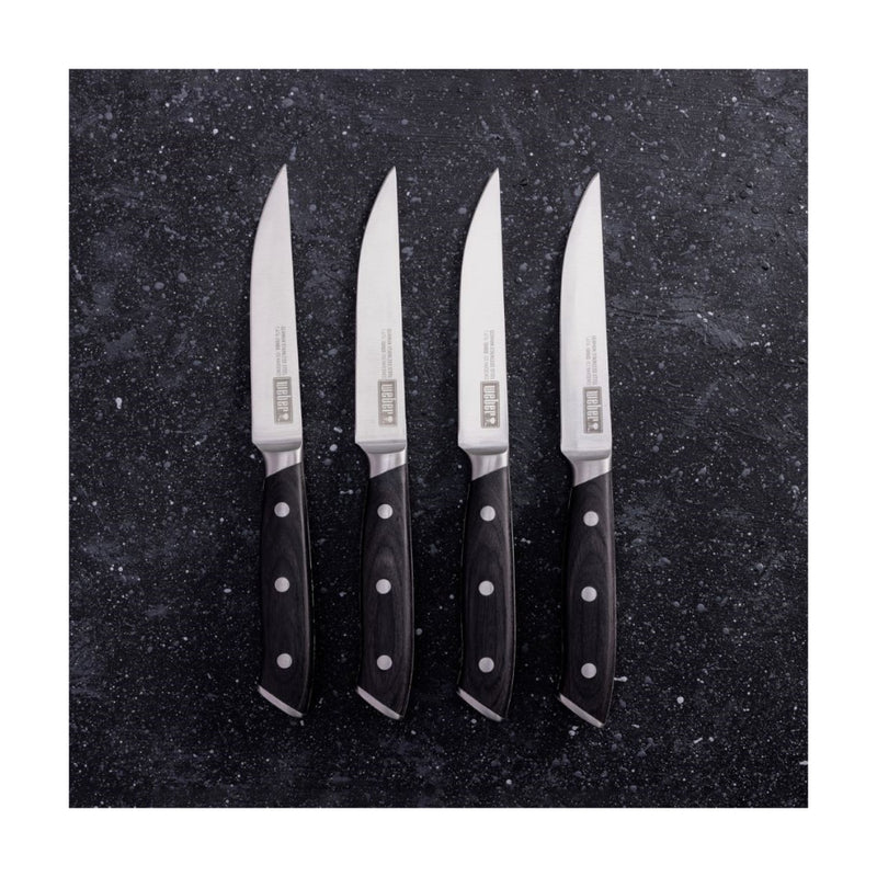 Stainless Steel | Weber Steak Knife Set Showing 4 Knives on Their Sides. 