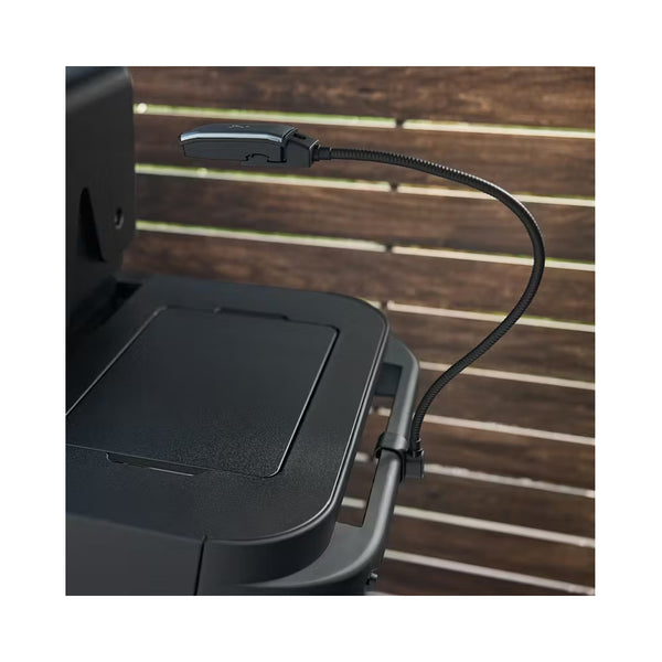 Black/Steel Grey | Weber Works Flexible  Lighting Image Showing The Light Attached To The Side Of A Webber BBQ.