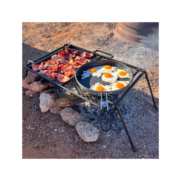 46 x 33 | Wildtrak Flat Plate And Grill Camp Cooker - Small  Image Showing Bacon And Eggs Being Cooked on The Plate.