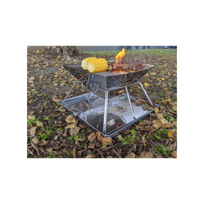 Stainless Steel | Wildtrak Frontier 360 Folding BBQ Firepit Image Showing Food Cooking On Firepit.