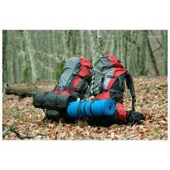 Blue | Wildtrak Deluxe Camper Mat Image Showing Mat Rolled up Attached To A Hiking Pack.